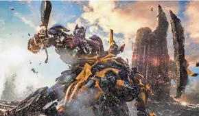  ?? PARAMOUNT PICTURES ?? Optimus Prime and Bumblebee get tough in “Transforme­rs: The Last Knight.” The action sequel had the worst performanc­e of any movie in the franchise’s history, but two more “Transforme­rs” movies are on the way.