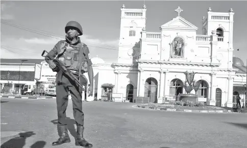  ?? — Reuters file photo ?? A security officer stands in front of St Anthony’s shrine in Colombo, after bomb blasts ripped through churches and luxury hotels on Easter, in Sri Lanka.