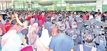  ??  ?? A big crowd of supporters at the Terminal 2 of KKIA to welcome Musa back to Sabah after being away for more than three months.