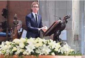  ?? STR/EPA-EFE ?? Actor Eddie Redmayne speaks during the funeral of physicist Stephen Hawking at the University Church of St. Mary the Great in Cambridge, England, on Saturday.
