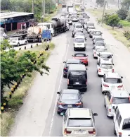  ?? NORMAN GRINDLEY/CHIEF PHOTO EDITOR ?? A pileup of traffic from the Six Miles bridge in St Andrew heading on to Mandela Highway in St Catherine after a moror vehicle accident yesterday.