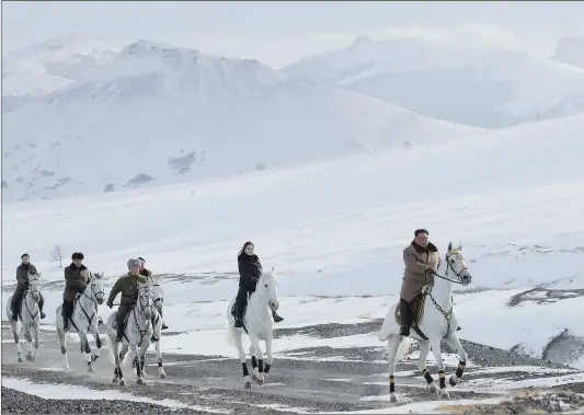  ?? Photo: AFP ?? Photo released by North Korea’s official Korean Central News Agency on Wednesday shows North Korean leader Kim Jong-un (right) on a horse as he visits battle sites at Mount Paektu, Ryanggang