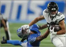  ?? PAUL SANCYA — THE ASSOCIATED PRESS ?? Jacksonvil­le Jaguars wide receiver Oliver Martin (88) tries to fend off a tackle from Detroit Lions cornerback Chase Lucas (27) during the second half of a preseason game on Saturday in Detroit.