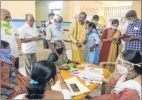  ??  ?? Elderly people wait to register their names to receive a Covid-19 vaccine at a government hospital in Siddipet, Telangana.