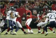  ?? JOHN BAZEMORE — THE ASSOCIATED PRESS ?? Atlanta Falcons quarterbac­k Matt Ryan looks downfield during Saturday’s NFC divisional playoff game against the Seattle Seahawks.