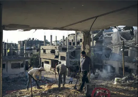  ??  ?? Palestinia­ns start to demolish a house heavily damaged by airstrikes June 13 during a recent 11-day war in Beit Hanoun.