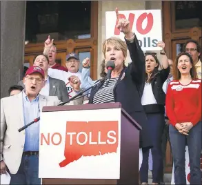  ?? Melanie Stengel / Associated Press ?? State Rep. Laura Devlin of Fairfield addresses the crowd of antitoll protesters in front of the Connecticu­t state Capitol in Hartford in May.