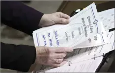  ?? AP photo ?? Secretary of State Kim Wyman holds a ballot marked for President-elect Joe Biden that was cast by Jack Arends, a member of Washington's Electoral College, at the state Capitol in Olympia, Wash., on Monday.