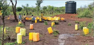  ??  ?? HOMELESS: Children collect water at one of the water tanks in the Palorinya refugee settlement. MSF delivers an average of 2 million litres per day from the Albert Nile River, which is delivered to tanks throughout the settlement­s by water trucks...