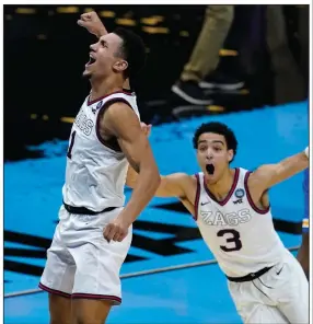  ?? (AP/Darron Cummings) ?? Gonzaga’s Andrew Nembhard (3) rushes to celebrate with teammate Jalen Suggs after Suggs hit a game-winning three-pointer against UCLA in the national semifinals Saturday night in Indianapol­is. More photos available at arkansason­line.com/44ncaa21.