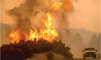  ?? NOAH BERGER/AFP/GETTY IMAGES ?? The Ranch fire, part of the Mendocino Complex fire, burns near Clearlake Oaks, California, on Sunday.