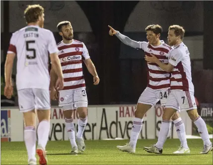 ??  ?? Midfielder Ross Callachan (second from right) celebrates after scoring against St Johnstone