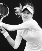  ?? JULIAN FINNEY / GETTY IMAGES ?? Canada’s Eugenie Bouchard plays
a backhand during her firstround singles victory over Galina
Voskoboeva on the first day of Wimbledon on Monday. Bouchard
won 5-7, 7-6 (5), 6-4.