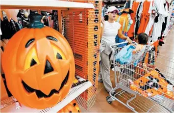  ?? DANNY JOHNSTON/AP ?? Serious Halloween savers need to shop Nov. 1 for things that will store well. Haunt your own home.