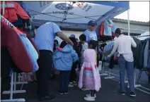  ?? COURTESY PHOTO ?? Volunteers from DCH Subaru of Riverside help families choose children’s coats at a Feb. 22 event. The Riverside dealership joined with Operation Warm and the Salvation Army Riverside Corps to donate more than 280 new coats for the event.