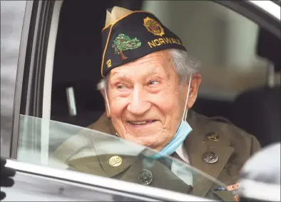  ?? Brian A. Pounds / Hearst Connecticu­t Media ?? Wearing his World War II uniform, veteran Nick Samodel celebrates his 100th birthday with a drive-by birthday parade outside his home on Jomar Road in Norwalk on Sunday.