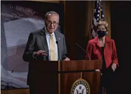  ?? DREW ANGERER/GETTY ?? Sens. Chuck Schumer, D-N.Y., and Elizabeth Warren, D-Mass., address eviction protection­s in the next coronaviru­s bill Wednesday at the Capitol.