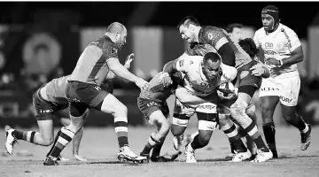  ?? — AFP photo ?? Racing’s Fijian lock Leone Nakarawa (third right) is tackled by Castres’ French lock Loic Jacquet (second right) during the French Top 14 rugby union match between Racing 92 and Castres Olympique at the Yves-du-Manoir Stadium in Colombes, near Paris in...