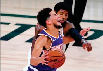  ?? AP PHOTO BY KEVIN C. COX/POO ?? Phoenix Suns’ Devin Booker draws a foul from Los Angeles Clippers’ Paul George, rear, during an NBA basketball game Tuesday, Aug. 4, 2020, in Lake Buena Vista, Fla.