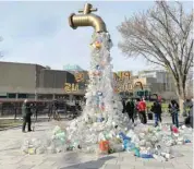  ?? — Reuters ?? A prop depicting a water tap with cascading plastic bottles is displayed by activists near the Shaw Centre in Ottawa, Ontario, Canada.