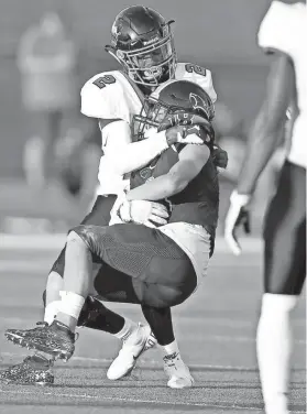  ?? BRYAN TERRY/THE OKLAHOMAN ?? Tulsa Washington's Gentry Williams tackles Southmoore's Kolton Bennett during a 51-7 win on Thursday night in Moore.