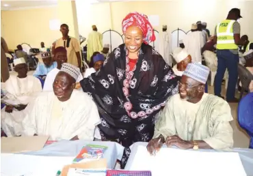  ??  ?? PTAD’s ES, Sharon Ikeazor, standing between two pensioners at a verificati­on excercise in Damaturu recently