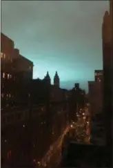  ?? ASSOCIATED PRESS ?? This photo shows blue light over New York, as seen from Manhattan, on Thursday. New York police said a transforme­r exploded at a Con Edison facility in Queens on Thursday, causing some power outages.