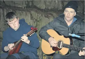  ?? Ahern) (Pic: John ?? Eamon and Eddie Quinlan from Carraig-na-bhFear, who performed during last Friday night’s vigil for Ashling Murphy at the Mass Rock in Glenville.