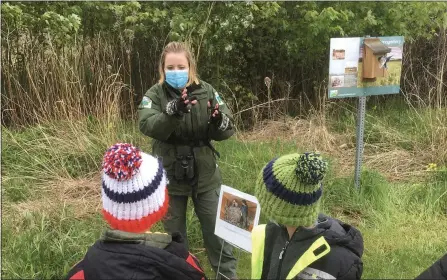  ?? BILL DEBUS - THE NEWS-HERALD ?? Lake Metroparks Interpreti­ve Naturalist Nicole Hindman explains informatio­n about birds at one of the educationa­l stations at Lake Erie Bluffs during the Return of the Birds event on May 8.