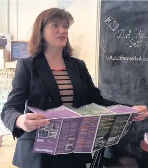  ??  ?? MP Nicky Morgan launches the new Charnwood visitor guide at Chocolate Alchemy in Loughborou­gh.