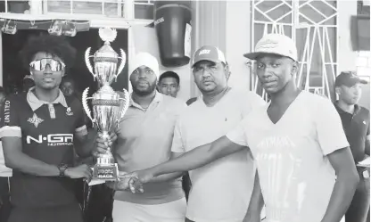  ??  ?? (l-r) Briton John receives his prize from Ojay Joseph of Jaggernaut­h Entertainm­ent, Therbhuwan Jagdeo and Junior Williams of Club Fiesta.