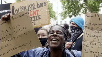  ?? KIRSTY WIGGLESWOR­TH — THE ASSOCIATED PRESS ?? Demonstrat­ors chant slogans during a rally at Downing Street in London, Tuesday, June 9, 2020. The rally is to commemorat­e George Floyd whose private funeral took place in the US on Tuesday.