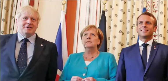  ??  ?? From left: Boris Johnson, Angela Merkel and Emmanuel Macron.