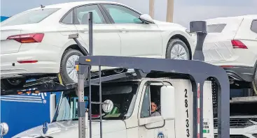  ?? JOSE CASTANARES / AFP / GETTY IMAGES ?? Trucks are loaded up at the Volkswagen plant in Puebla, Mexico. Mexican President-elect Andres Manuel Lopez Obrador’s advisers Monday hailed a new trade deal with the U.S.