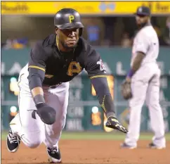  ?? Keith Srakocic / The Associated Press ?? Pittsburgh pinch-runner Starling Marte dives for third during Saturday’s game.
