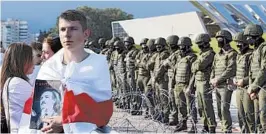  ?? AP ?? With Belrusian soldiers standing guard, a man draped in the country’s flag holds a picture of President Alexander Lukashenko with the words, “Happy birthday to you Sasha.”