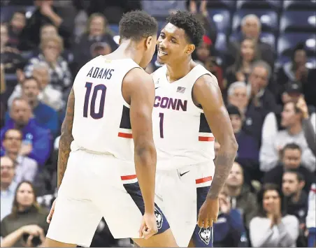  ?? Jessica Hill / Associated Press ?? UConn’s Brendan Adams (10) celebrates with Christian Vital in the first half of Wednesday’s win voer Temple.