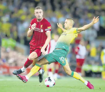  ?? AP ?? Norwich City’s Moritz Leitner (right) tries to stop Liverpool’s Joe Gomez during the English Premier League match between Liverpool and Norwich City at Anfield in Liverpool, England, yesterday. Liverpool won 4-1.
