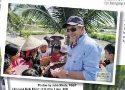  ?? Photos by John Riedy, TGGF ?? (Above) Bob Ellert of Battle Lake, MN, giving gifts of candy and school supplies to the Vietnamese children at Ap Bac Village.
