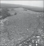  ?? THE ASSOCIATED PRESS FILE ?? This file photo shows a crowd of about 400,000people attending the Woodstock Music and Arts Festival in Bethel, N.Y. Woodstock was staged 80miles northwest of New York City on a bucolic hillside owned by dairy farmer Max Yasgur. It was great spot for peaceful vibes, but miserable for handling the hordes coming in by car.