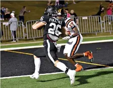  ?? Photo by Kevin Sutton ?? ■ Pleasant Grove slotback Logan Johnson breaks for the end zone under pressure from a Gilmer defender during the first half of play Friday at Hawk Stadium. Johnson scored on the run to give the Hawks a 7-3 lead.