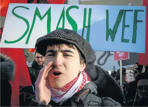  ?? Picture: Fabrice Coffrini/AFP ?? People protest at the World Economic Forum’s annual meeting in Davos, Switzerlan­d, this week.