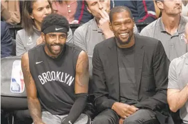 ?? AP & GETTY ?? Nets’ future appears bright with superstars Kyrie Irving and Kevin Durant, and they’ll have a new coach next season after the surprise firing of Kenny Atkinson (r.) on Saturday morning.