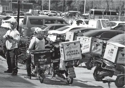  ??  ?? Drivers of food delivery service Meituan are seen in Beijing in file photo. The company is seeking over US$4 billion as it files for a Hong Kong IPO yesterday. — Reuters