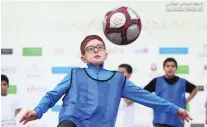  ?? Delores Johnson / The National ?? Yahya Zaher, 10, puts his football skills to the test at the National Sports Day at Zayed Sports City.