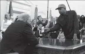  ?? OLIVIER DOULIERY/ABACA PRESS ?? U.S. President Donald Trump, left, hosts a working lunch with musical artist Kanye West to discuss criminal justice system and prison reform on Thursday in the Oval Office of the White House in Washington, D.C.