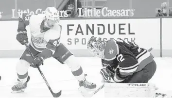  ?? PAUL SANCYA/AP ?? Panthers goaltender Sergei Bobrovsky, right, stops the shot of Red Wings left wing Darren Helm in the second period Saturday in Detroit.