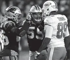  ?? JEFF SINER/TRIBUNE NEWS SERVICE ?? Carolina Panthers cornerback Daryl Worley, left, and linebacker Luke Kuechly, center, argue with Tokay High graduate and Miami Dolphins tight end Julius Thomas following a second-quarter play in Charlotte, N.C., on Monday.