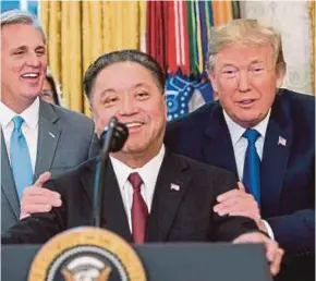  ?? AFP PIC ?? United States President Donald Trump sharing a light moment with Broadcom chief executive officer Tan Hock Eng at the White House in Washington DC on Thursday as the latter announcing his company’s repatriati­on plan to the US.