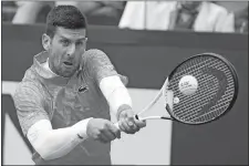  ?? GREGORIO BORGIA/AP PHOTO ?? Novak Djokovic returns the ball to Holger Rune during their quarterfin­al match on May 17 at the Italian Open in Rome.